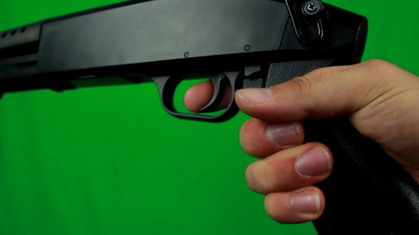 Putting Finger On A Trigger And Holding Shotgun