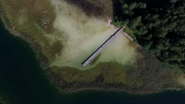Slow Vertical Landing Over The Lake With Small Bridge Near Forest 2