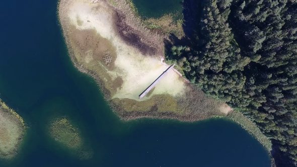 Slow Vertical Landing Over The Lake With Small Bridge Near Forest 1