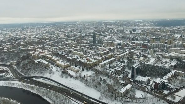 Aerial View Over The City Near River And Forest, Winter