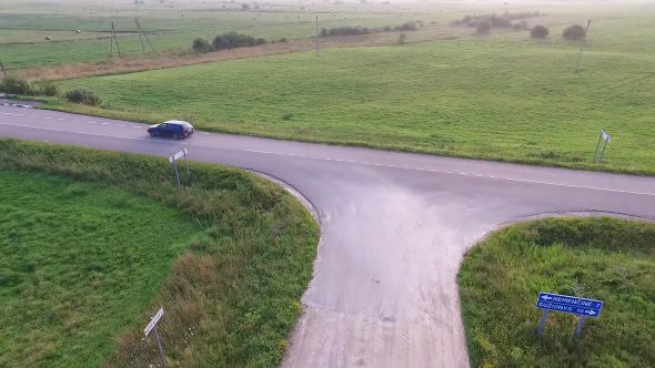 Aerial View, Car Leaving Gravel Road In Country