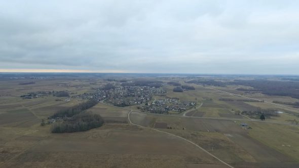 Flight Upwards Over Small Town In Distance
